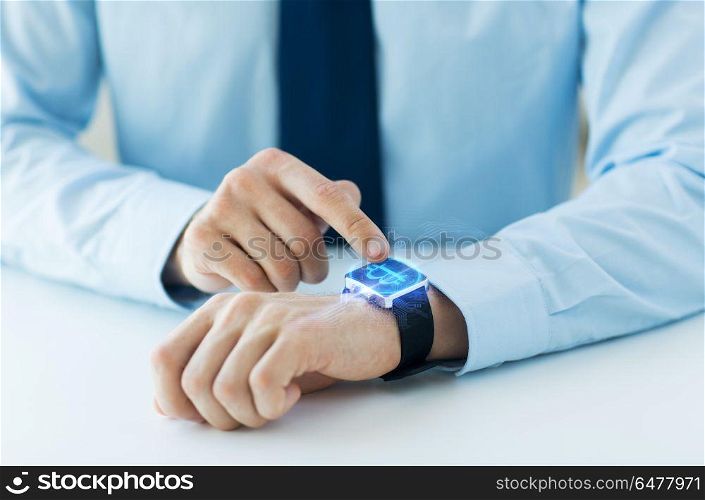 business, technology and cryptocurrency concept - close up of male hand wearing smart watch with bitcoin on screen. close up of hands with bitcoin on smart watch. close up of hands with bitcoin on smart watch