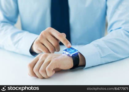 business, technology and cryptocurrency concept - close up of male hand wearing smart watch with bitcoin on screen. close up of hands with bitcoin on smart watch. close up of hands with bitcoin on smart watch