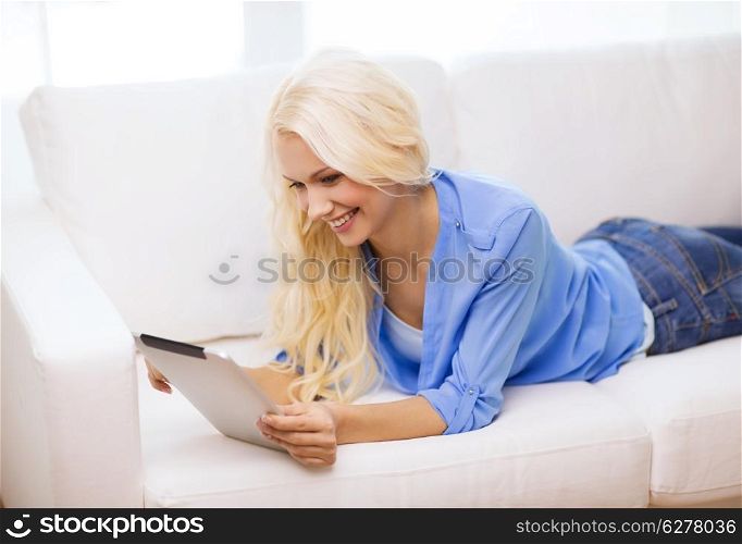 business, technology and e-learning concept - smiling woman with tablet pc computer at home