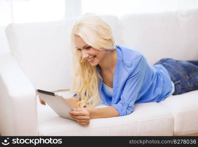 business, technology and e-learning concept - smiling woman with tablet pc computer at home