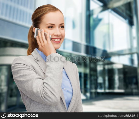 business, technology and education concept - friendly young smiling businesswoman with smartphone