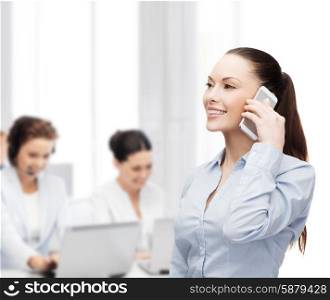 business, technology and education concept - friendly young smiling businesswoman with smartphone in office
