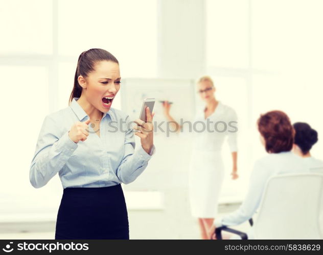 business, technology and education concept - screaming businesswoman with smartphone in office