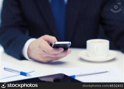 business, technology and interent concept - businessman with smartphone reading news