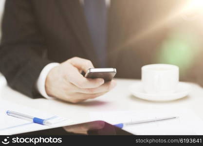 business, technology and interent concept - businessman with smartphone reading news