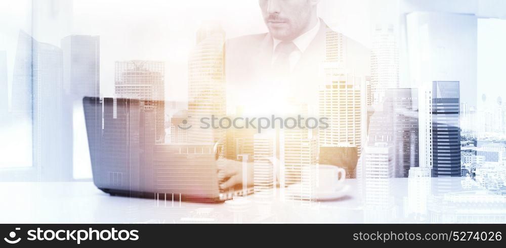 business, technology and internet concept - businessman with laptop computer and coffee at office over city background and double exposure effect. businessman with laptop and coffee at office