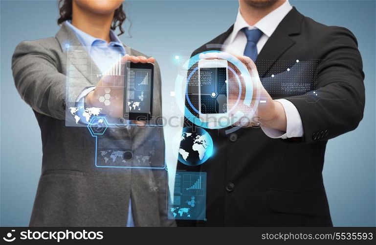 business, technology and internetconcept - businessman and businesswoman with chart and graphs on smartphone screens