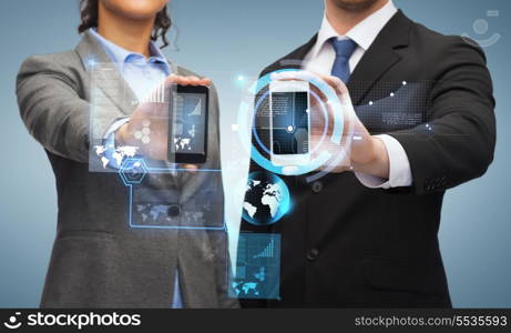 business, technology and internetconcept - businessman and businesswoman with chart and graphs on smartphone screens