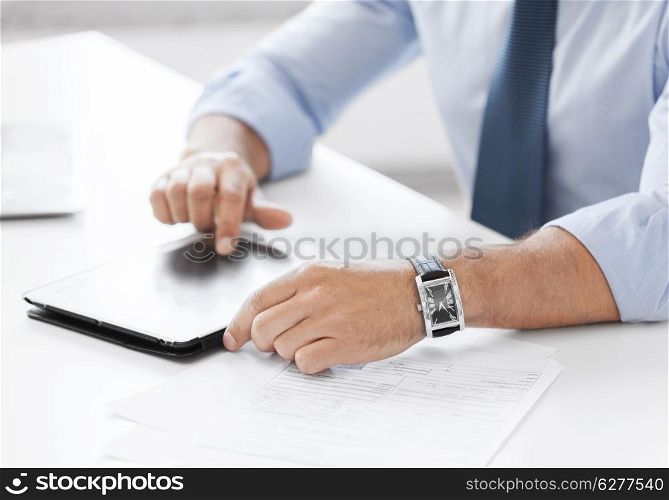 business, technology and office concept - businessman with tablet pc in office