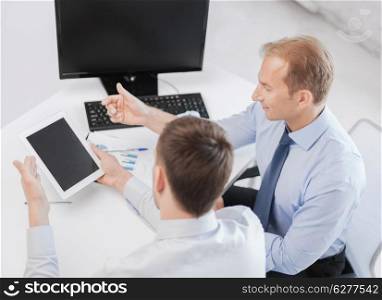 business, technology and office concept - businessmen with notebook and tablet pc