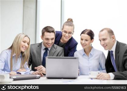 business, technology and office concept - smiling business team with laptop computers and coffee having discussion in office