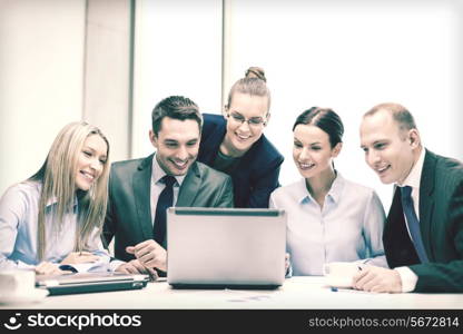 business, technology and office concept - smiling business team with laptop computers and coffee having discussion in office