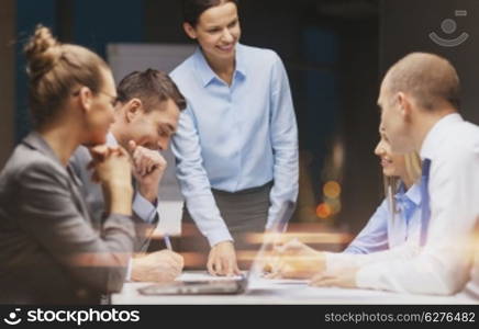 business, technology and office concept - smiling female boss talking to business team