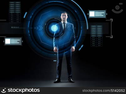 business, technology and people concept - businessman in suit and virtual projection over black background. businessman in suit with virtual projection