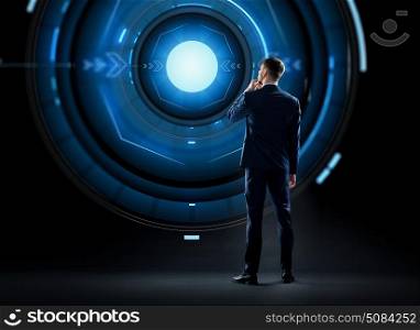 business, technology and people concept - businessman in suit looking at virtual projection over black background. businessman in suit looking at virtual projection. businessman in suit looking at virtual projection