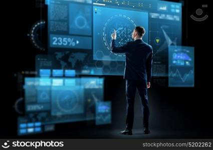 business, technology and people concept - businessman in suit touching virtual screen over black background. businessman in suit touching virtual screen