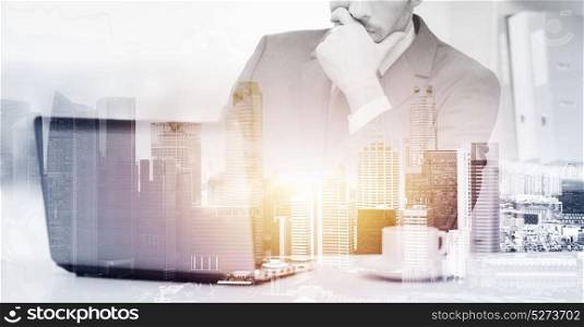 business, technology and people concept - businessman with laptop computer and coffee at office over city background and double exposure effect. businessman with laptop and coffee at office