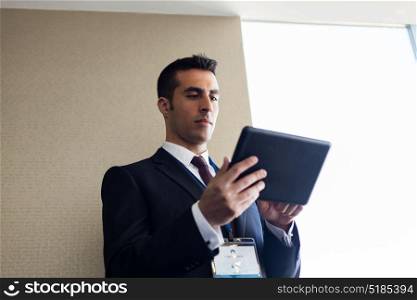 business, technology and people concept - businessman with tablet pc computer at office. businessman with tablet pc computer at office