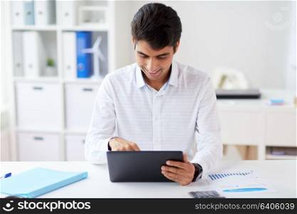 business, technology and people concept - businessman working with tablet pc computer at office. businessman working with tablet pc at office