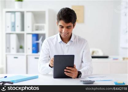 business, technology and people concept - businessman working with tablet pc computer at office. businessman working with tablet pc at office