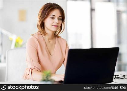 business, technology and people concept - businesswoman with laptop computer working at office. businesswoman with laptop working at office. businesswoman with laptop working at office
