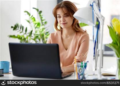 business, technology and people concept - businesswoman with laptop computer working at office. businesswoman with laptop working at office. businesswoman with laptop working at office