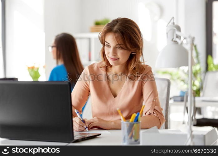 business, technology and people concept - businesswoman with laptop computer working at office. businesswoman with laptop working at office. businesswoman with laptop working at office