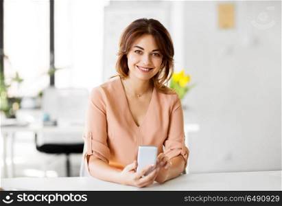 business, technology and people concept - businesswoman with smartphone working at office. businesswoman with smartphone working at office. businesswoman with smartphone working at office