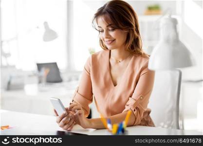 business, technology and people concept - businesswoman with smartphone working at office. businesswoman with smartphone working at office. businesswoman with smartphone working at office