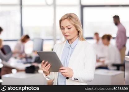 business, technology and people concept - businesswoman with tablet pc computer at office. businesswoman with tablet pc computer at office