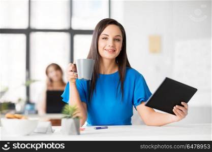 business, technology and people concept - businesswoman with tablet pc computer drinking coffee at office. businesswoman with tablet pc and coffee at office. businesswoman with tablet pc and coffee at office