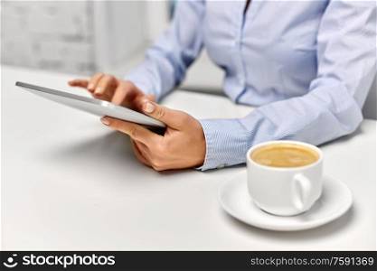 business, technology and people concept - businesswoman with tablet pc computer drinking coffee at office. businesswoman with tablet pc and coffee at office