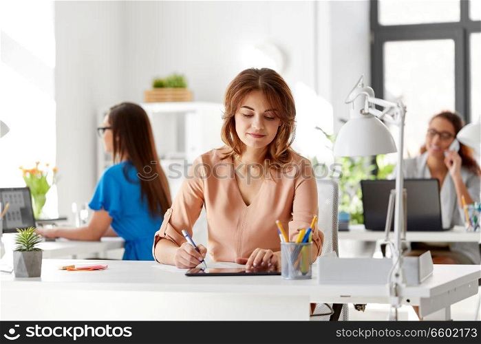 business, technology and people concept - businesswoman with tablet pc computer working at office. businesswoman with tablet pc working at office
