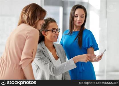 business, technology and people concept - businesswomen with smartphone working at office. businesswomen with smartphone working at office