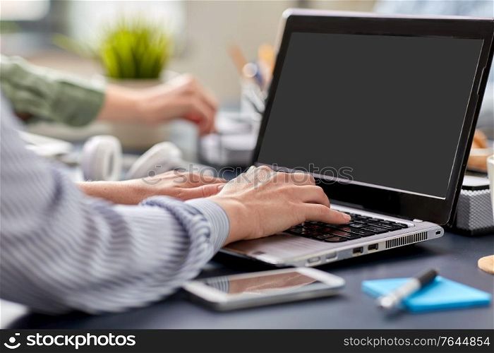business, technology and people concept - close up of hands with laptop computer working at office. businesswoman with laptop working at office