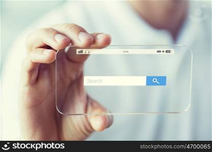 business, technology and people concept - close up of male hand holding and showing transparent smartphone with internet browser search bar
