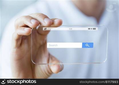 business, technology and people concept - close up of male hand holding and showing transparent smartphone with internet browser search bar