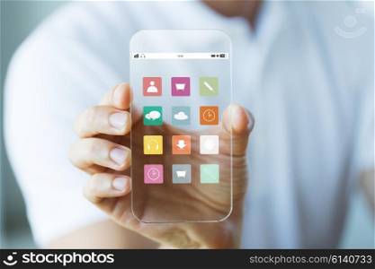business, technology and people concept - close up of male hand holding and showing menu icons on transparent smartphone screen