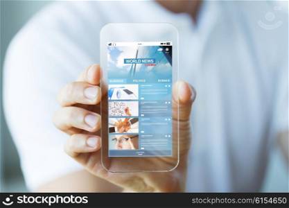 business, technology and people concept - close up of male hand holding and showing transparent smartphone with world news web page on screen
