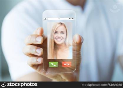 business, technology and people concept - close up of male hand holding and showing transparent smartphone with incoming call on screen
