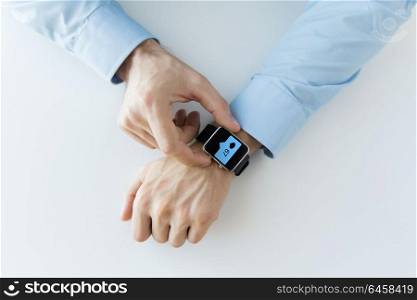 business, technology and people concept - close up of male hands wearing smart watch with social media icons. hands with smart watch and social media icons