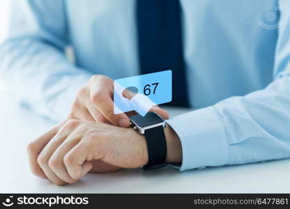 business, technology and people concept - close up of male hands wearing smart watch with social media icons. hands with smart watch and social media icons. hands with smart watch and social media icons