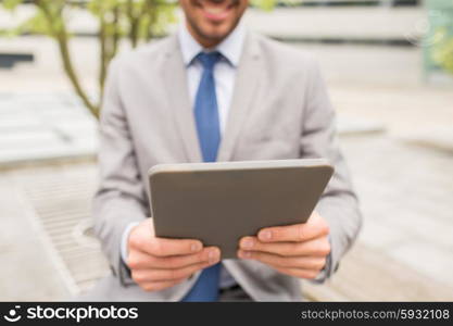 business, technology and people concept - close up of smiling man with tablet pc computer in city