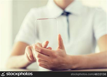 business, technology and people concept - close up of woman hand holding and showing transparent smartphone at home