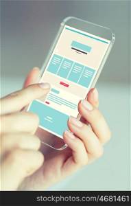 business, technology and people concept - close up of woman hand holding and showing transparent smartphone web page design on screen