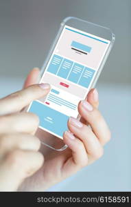 business, technology and people concept - close up of woman hand holding and showing transparent smartphone web page design on screen