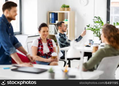 business, technology and people concept - creative man with smartphone at office coffee break. creative man with smartphone at office. creative man with smartphone at office