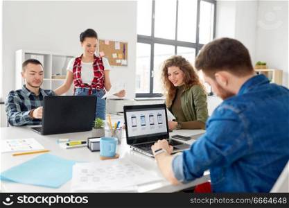 business, technology and people concept - creative team or designers working on user interface at office. creative team working on user interface at office