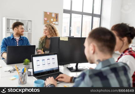 business, technology and people concept - creative team or designers working on user interface at office. creative team working on user interface at office