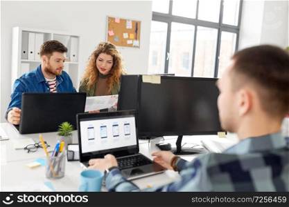business, technology and people concept - creative team or designers working on user interface at office. creative team working on user interface at office